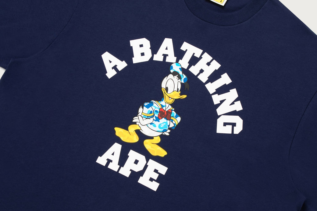 BAPE X DISNEY 】DONALD DUCK COLLEGE RELAXED FIT TEE | bape.com