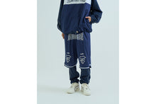 LAYERED TRACK PANTS